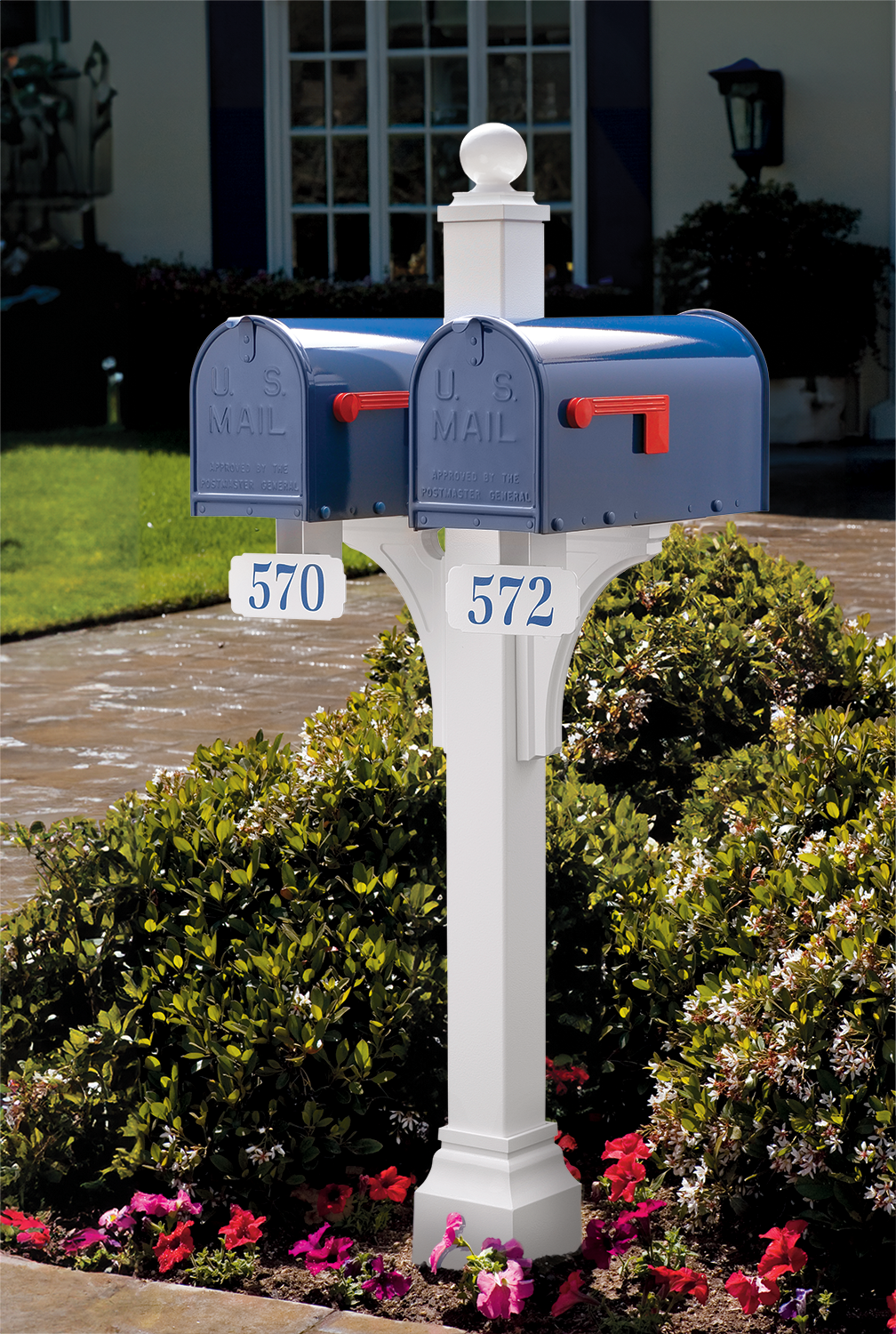 Premium blue U.S. mailboxes with durable finishes on an elegant white post, accented by curated blooms and upscale landscaping.