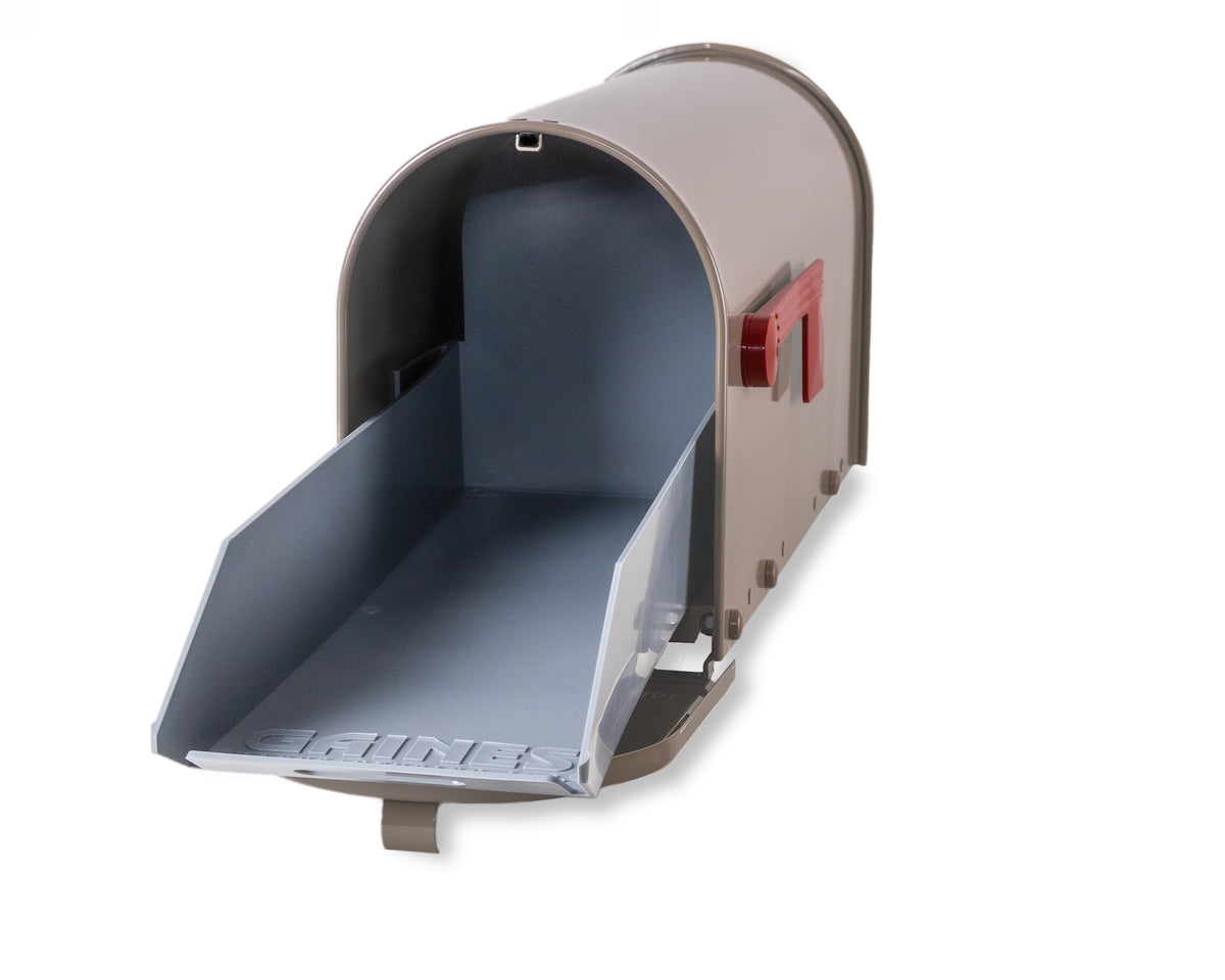 A Janzer Sliding Mailbox Tray by Gaines Manufacturing Inc is displayed in an elegant gray finish, its robust front door open to showcase a spacious, immaculately crafted interior. The distinctive red flag stands upright on the side, seamlessly blending modern functionality with premium curb appeal—an enduring choice designed for discerning homeowners and prestigious communities who value both superior materials and sophisticated design.